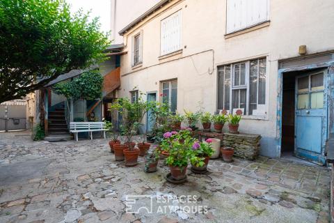 Property complex set around a cobblestone courtyard, in need of renovation