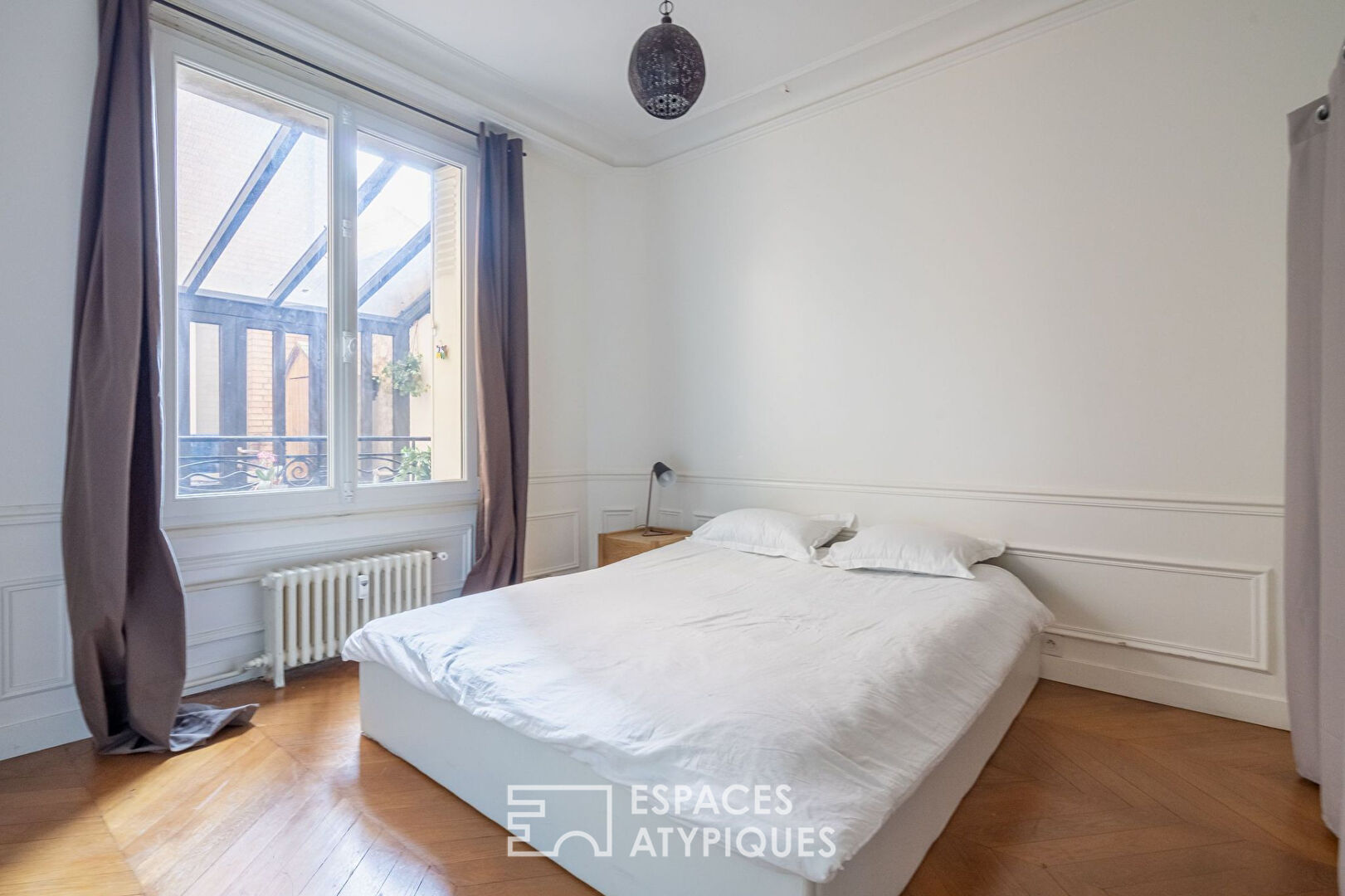 Appartement bourgeois avec véranda face au parc des Buttes Chaumont